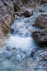 ein Gebirgsbach rauscht zwischen den Felsen