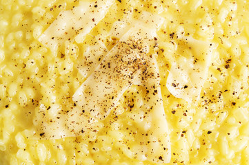 risotto decorated with parmesan stripes and sprinkled withblack pepper