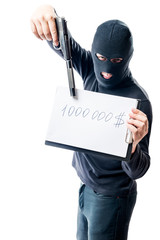 Bandit in black clothes showing weapons, in the amount of ransom for hostages