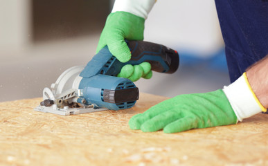 Carpenter sawing timber, closeup