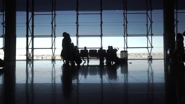 Silhouettes of Travellers in Airport - Hong Kong International Airport Terminal.