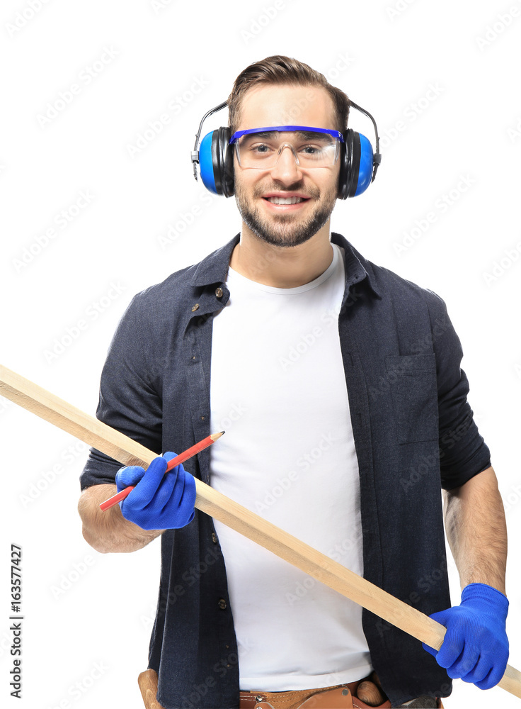 Wall mural Smiling carpenter holding wooden plank on white background