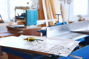 Table with drawing in carpenter's workshop