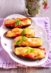 Stuffed eggplants with cheese topping