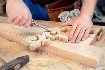 Carpenter with chisel in workshop, closeup