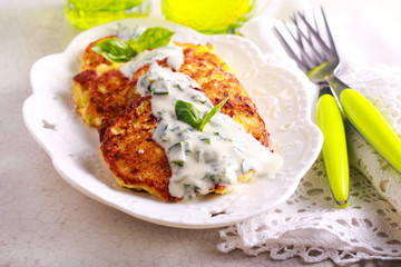 Courgette and feta fritters with yogurt and herb sauce