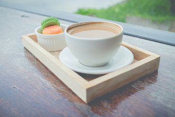 hot coffee breakfast set with fresh macaroon in outdoor bakery house cafe(vintage)