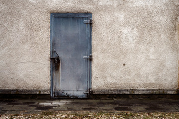 Old gray steel door on a wall