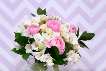 Beautiful bouquet with white freesia on color background