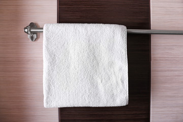 Clean white towel on hanger in bathroom