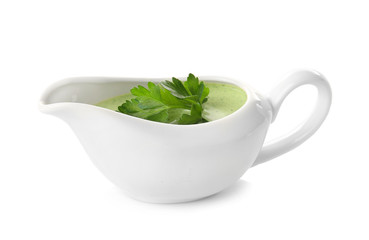 Delicious yogurt sauce with parsley leaves in gravy boat isolated on white