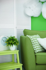 Marvelous green tints with cozy armchair in interior