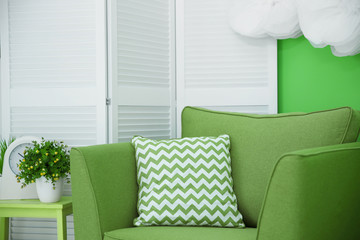Marvelous green tints with cozy armchair in interior
