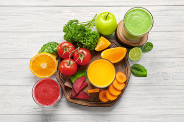 Fresh smoothies, vegetables and fruits on table