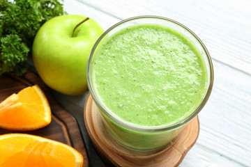 Fresh smoothie, fruits and herbs on table