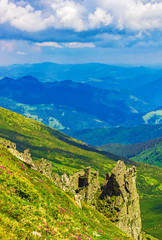 Panoramic view of the sky and mountain ridges from the top of the mountain in a sunny summer day