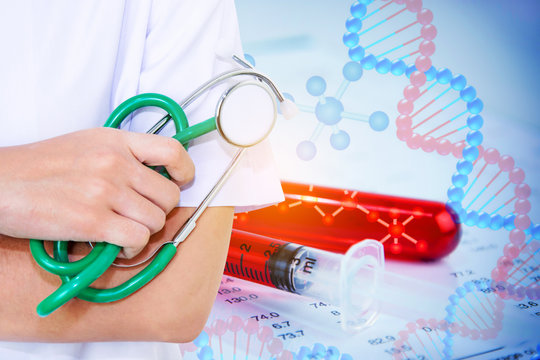 Doctor or nurse with stethoscope on tube with DNA testing of the blood in the laboratory with blood sample collection tubes and syringe background.