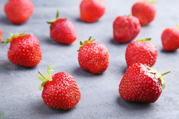 Fresh strawberries on grey wooden table