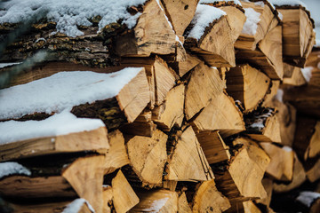 Pile Of Chopped Wood With Snow On Top