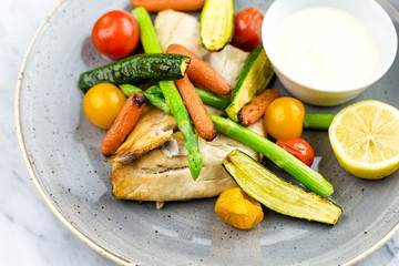Grilled fish and vegetables with sauce