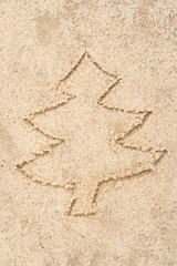 Fototapeta na wymiar Christmas tree drawing in sand