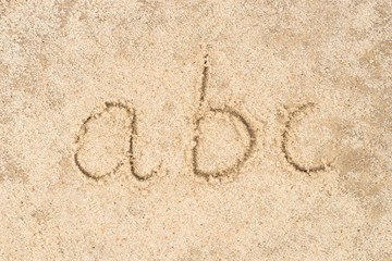 abc letters written in sand