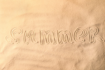 Fototapeta na wymiar Word SUMMER written on sea sand