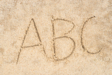 abc letters written in sand