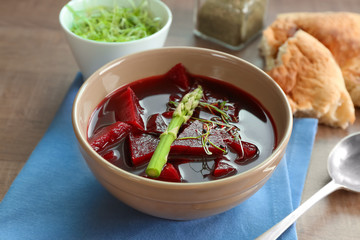 Delicious beet soup with asparagus and wheat germ on kitchen table