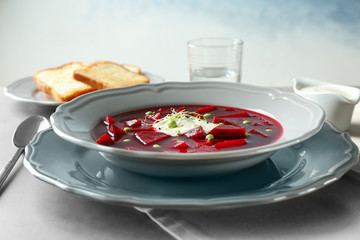Delicious beet soup with wheat germ and peas on kitchen table
