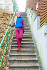Fototapeta na wymiar Woman wearing sportswear exercising outside during autumn