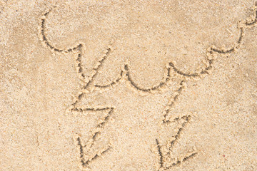stormy clouds drawing in sand