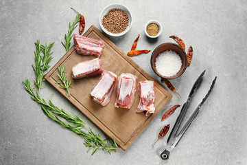 Raw ribs with spices on kitchen table
