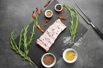 Raw ribs with spices on kitchen table