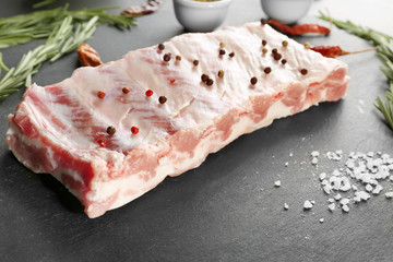 Raw ribs with spices on kitchen table