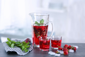 Delicious strawberry lemonade in glassware on kitchen table