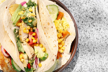 Plate with delicious fish tacos on table