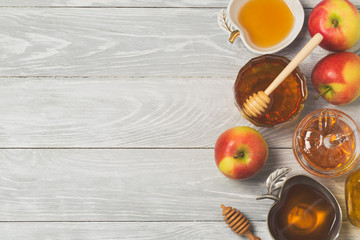 Rosh hashanah jewish new year holiday celebration concept. Honey and apples over wooden background. Top view