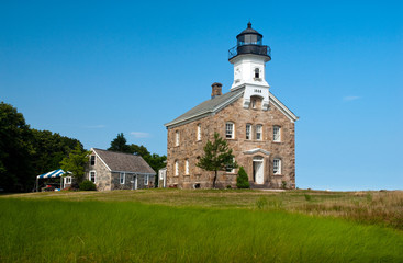Fototapeta na wymiar Sheffield Island lighthouse on a summer day in Connecticut. It is located on one of the Norwalk islands and hosts many events for tourists.