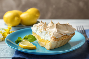 Piece of delicious lemon meringue pie on plate