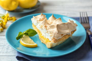 Piece of delicious lemon meringue pie on plate
