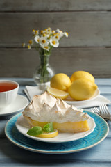 Piece of delicious lemon meringue pie on plate