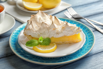 Piece of delicious lemon meringue pie on plate