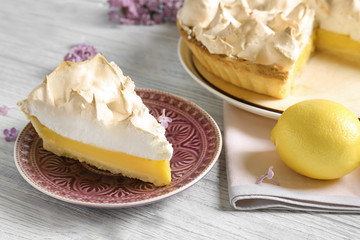 Piece of delicious lemon meringue pie on plate