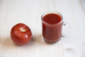 Cup of tomato juice and whole tomato