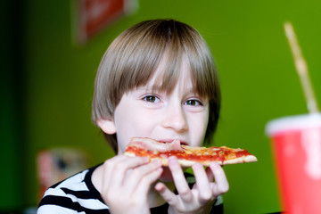 Portrait of a child at a table in a pizzeria