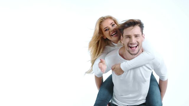 Sexy young couple posing on studio background, 4k slow motion studio clip