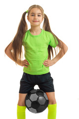 vertical portrait sports little girl who holds the ball between legs