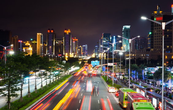 NANNING, CHINA - Qingxiu District busy traffic with light trails and high illuminated  buildings