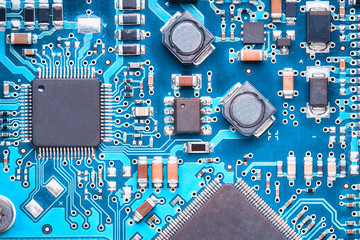 macro top view of a printed circuit board with processors, capacitors and transistors